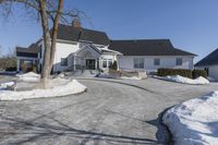 an empty house has no roof on a clear winter day with snow piled up all around