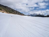 skis are being pulled up to a mountain side as people ride in snowboards