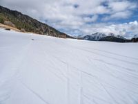 skis are being pulled up to a mountain side as people ride in snowboards