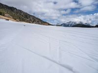 skis are being pulled up to a mountain side as people ride in snowboards