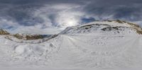 the snow is piled up on the top of the mountain on a sunny day in the mountains