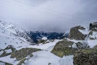 a view of a snow covered mountain from the top of a snowy hill range in europe