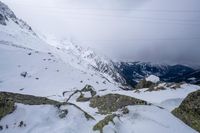 a view of a snow covered mountain from the top of a snowy hill range in europe