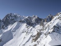 a person on skis goes down a snowy mountain slope side with some very majestic snow