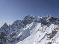 a person on skis goes down a snowy mountain slope side with some very majestic snow