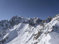 a person on skis goes down a snowy mountain slope side with some very majestic snow