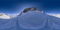 the mountains in front of a clear blue sky are covered with snow and ice floes