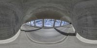 a view of snow - covered mountains from an abandoned looking structure with one section cut open