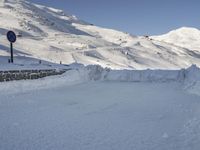 a skier is coming down a hill covered in snow and another skier is behind him