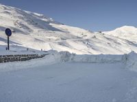 a skier is coming down a hill covered in snow and another skier is behind him