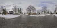 there are several pictures taken using a fisheye lens to see snow around the road