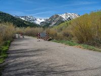 an open gate sits behind a warning sign on the side of the road that's blocked off