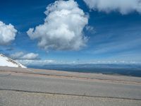 the man is at the top of a mountain on skis with mountains in the background