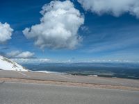 the man is at the top of a mountain on skis with mountains in the background