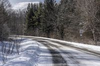 Snow Covered Road in Forest, Canadian Landscape