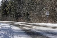 Snow Covered Road in Forest, Canadian Landscape