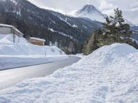 a road with lots of snow on it and a person riding a red skis