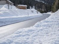 a road with lots of snow on it and a person riding a red skis