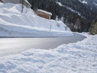a road with lots of snow on it and a person riding a red skis