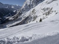 an image of a skier on a slope going down the mountain side on the snow