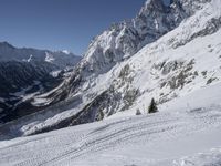 an image of a skier on a slope going down the mountain side on the snow