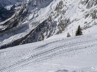 an image of a skier on a slope going down the mountain side on the snow