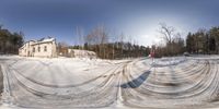 an image of a city street taken from the snow covered road and looking at a stop sign