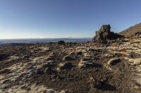 the snow - covered rocky terrain on the slopes of a mountain near mount kenya with mt kilimore in the background