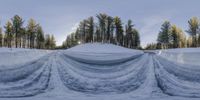 an image of snow covered ski slope at a resort or ski slope with trees in the background