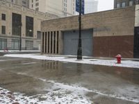 a street pole sitting on top of snow covered ground near tall buildings in the city