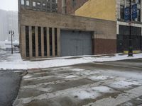 a street pole sitting on top of snow covered ground near tall buildings in the city