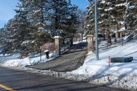 there is a street sign in front of the snow covered parka hill at a stop light