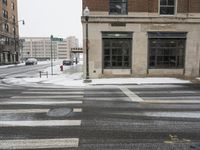 there is snow on the street and an intersection in the street is white in color