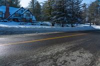 the house on the road has been partially submerged in snow and ice on it's side