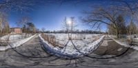 there is a street corner with a circular view of a snow covered sidewalk on it