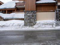 a snow boarder riding down the side of a street in front of a building