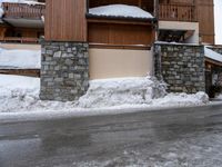 a snow boarder riding down the side of a street in front of a building