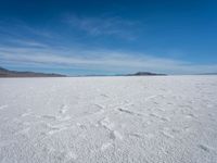 a lone snowboarder makes his way through the salt flats of salar de atasca, in bolivia