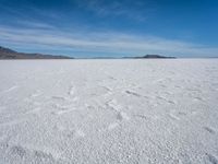 a lone snowboarder makes his way through the salt flats of salar de atasca, in bolivia