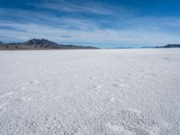 a lone snowboarder makes his way through the salt flats of salar de atasca, in bolivia