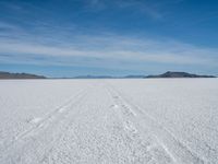 a lone snowboarder makes his way through the salt flats of salar de atasca, in bolivia