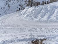 there is snow everywhere that has been cleared off the road with ski equipment on it