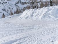 there is snow everywhere that has been cleared off the road with ski equipment on it