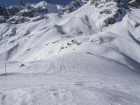 a man riding skis down the side of a snow covered mountain slope top in winter