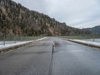 a road that is not covered in snow and ice, leads off into the distance