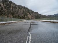 a road that is not covered in snow and ice, leads off into the distance