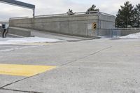 an intersection in the snow with one side showing and the other showing yellow painted on it