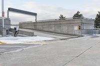 an intersection in the snow with one side showing and the other showing yellow painted on it