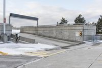 an intersection in the snow with one side showing and the other showing yellow painted on it