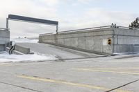 an intersection in the snow with one side showing and the other showing yellow painted on it